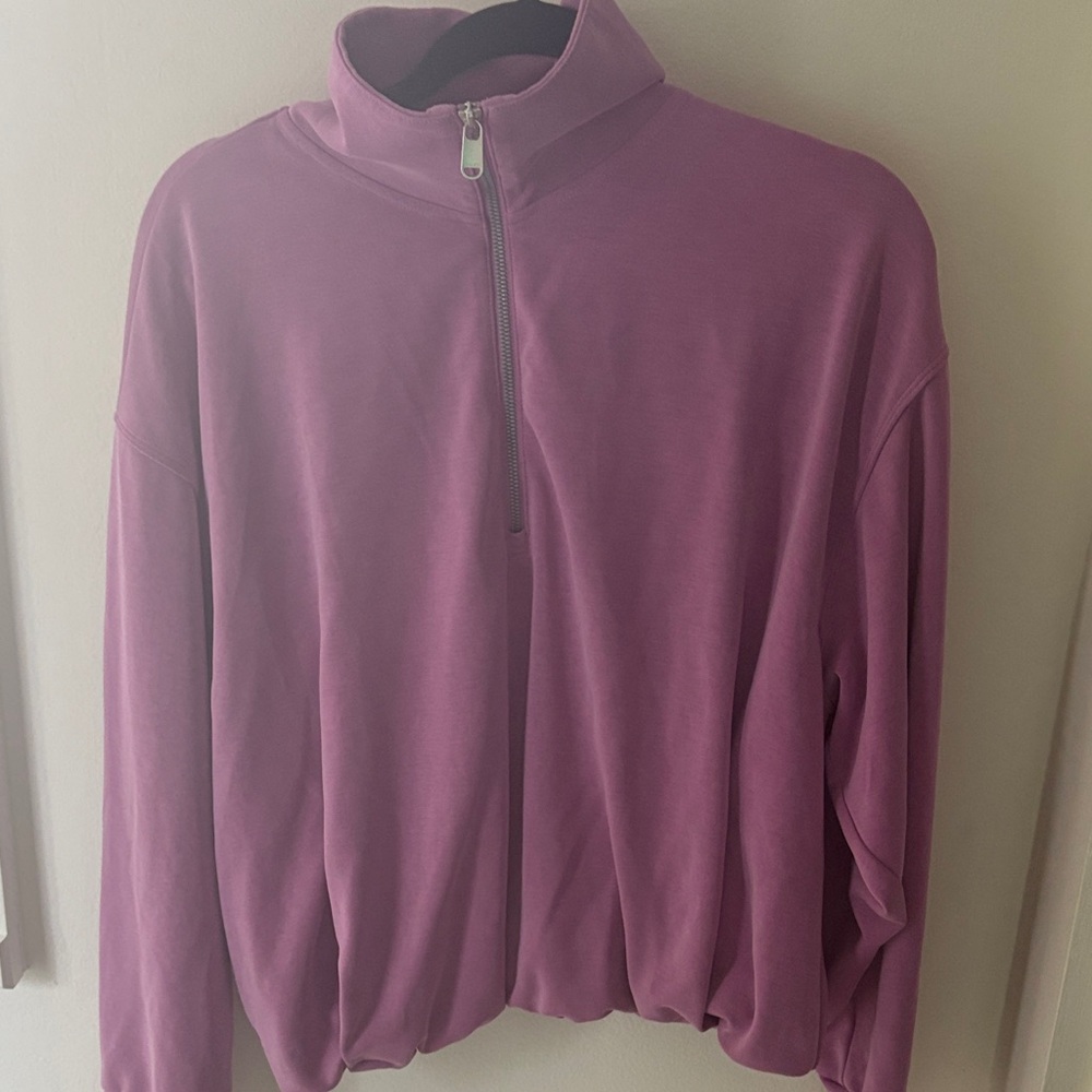 Raspberry Half-Zip Pullover with front pocket and bubble hem.